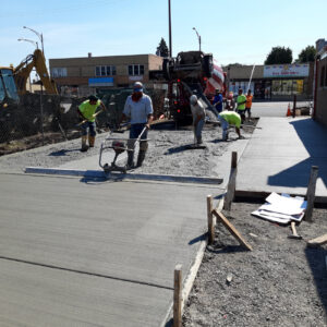 Concrete paving workers construction site