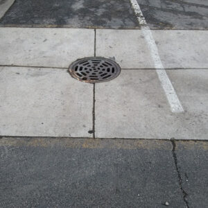 Concrete pavement with drainage grate