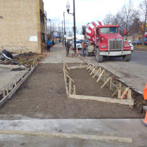 Sidewalk construction with concrete mixer