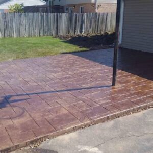 Stamped backyard concrete patio installation